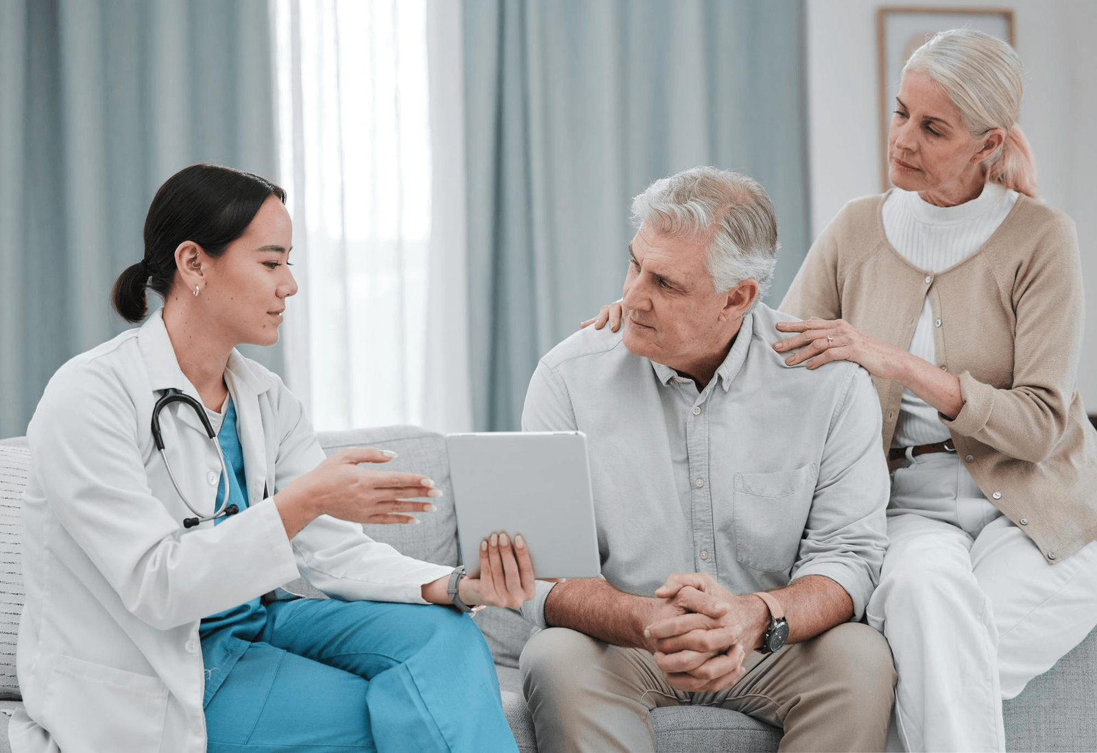 An older adult smiling with a caregiver