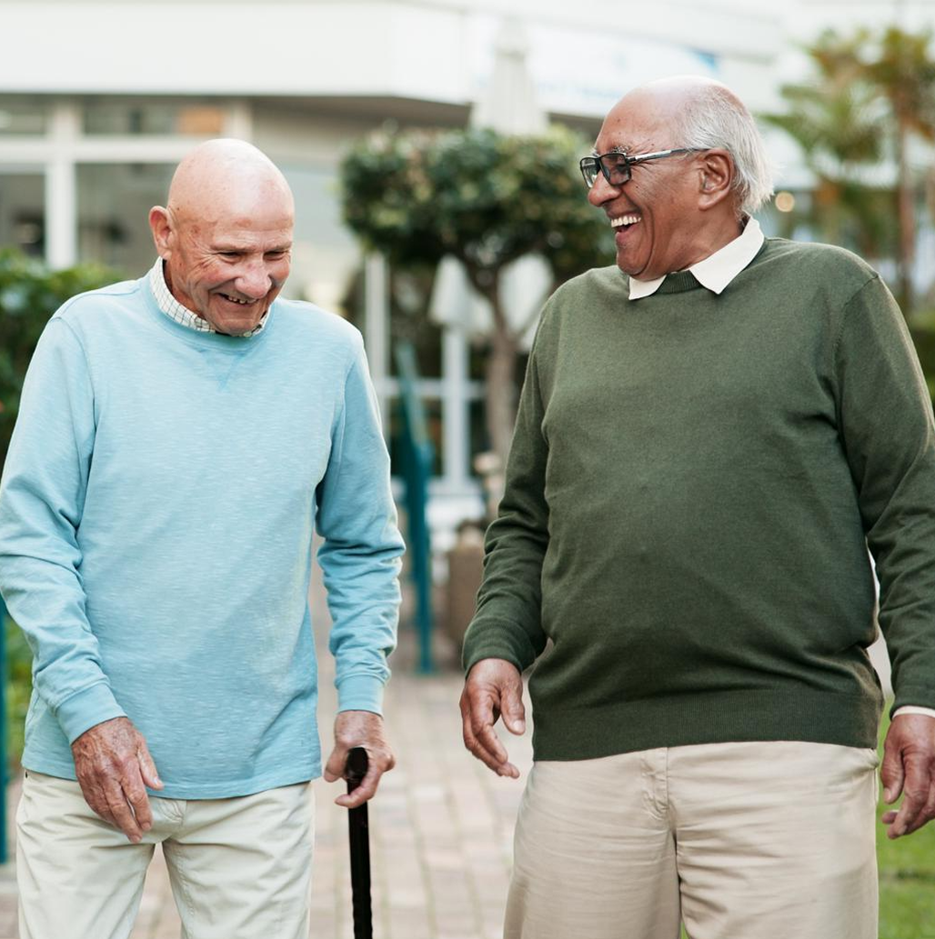 Two older adults walking together outdoors